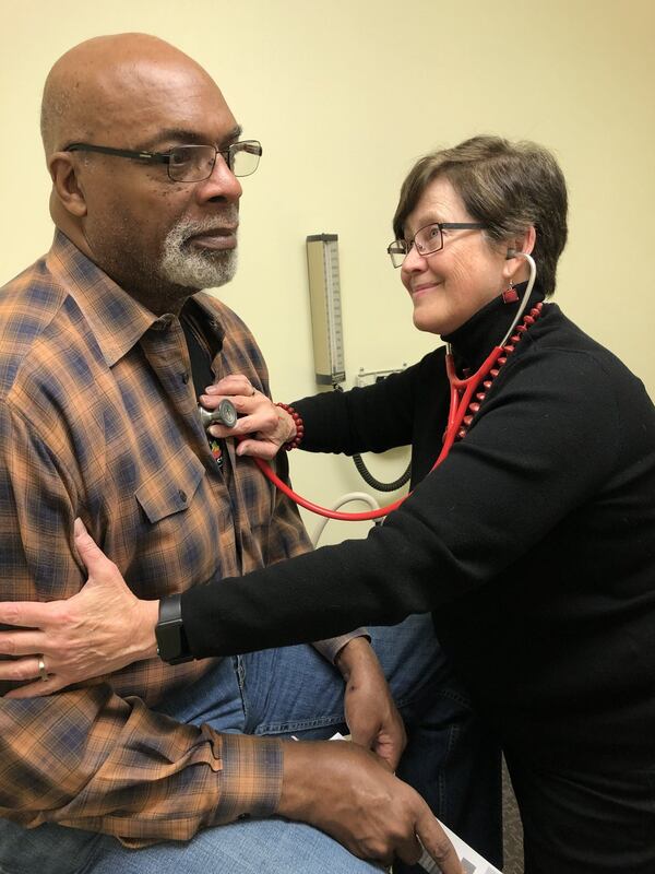 Dr. Melanie Thompson examines a patient recently at her practice in Atlanta. CONTRIBUTED