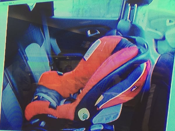 The prosecution shows the jury a crime scene photo that shows how Cooper's car seat was positioned in the back seat of the SUV, during Justin Ross Harris' murder trial at the Glynn County Courthouse in Brunswick, Ga., Wednesday, Oct. 5, 2016. (screen capture via WSBTV)