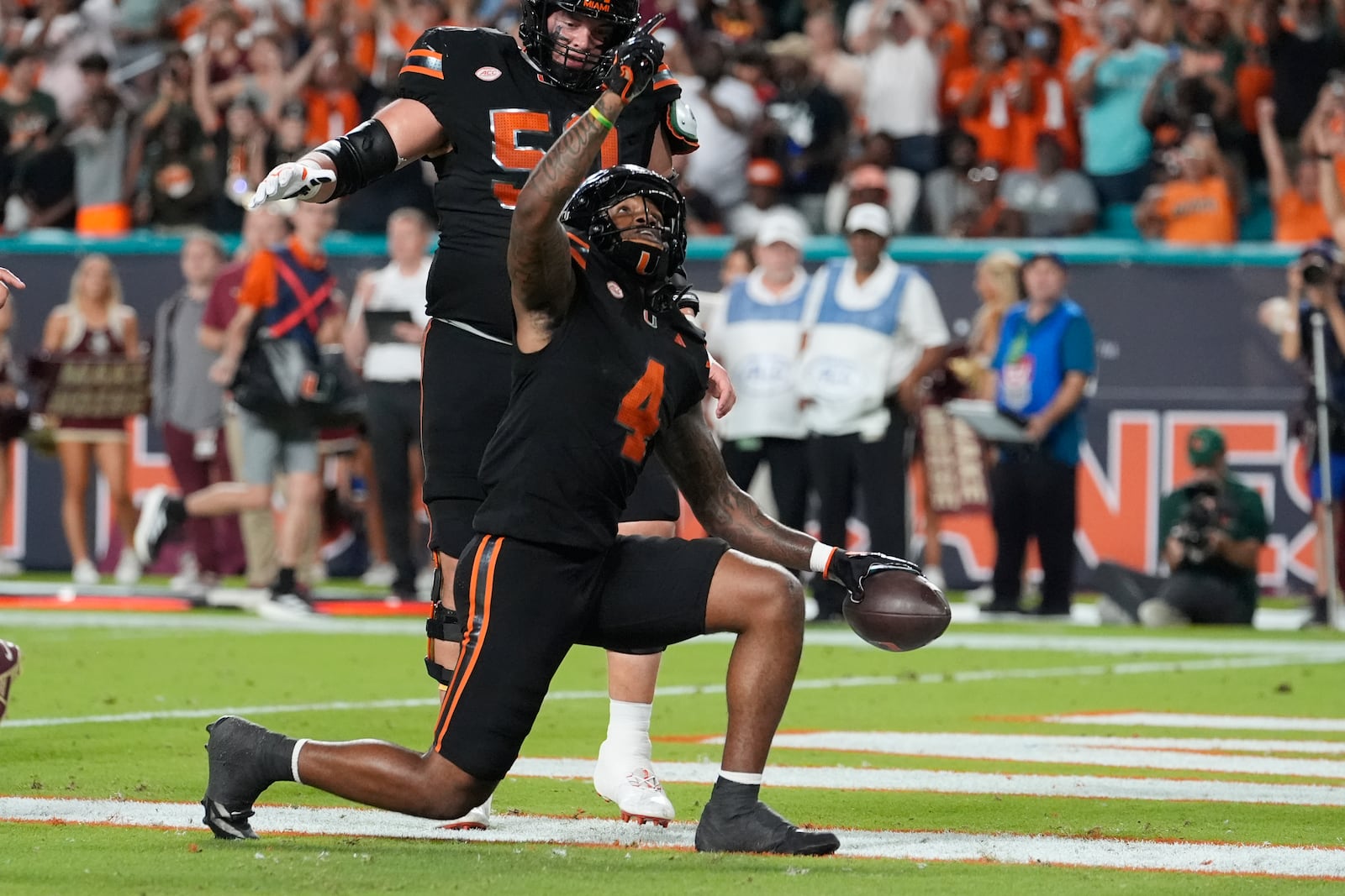 Miami running back Mark Fletcher Jr. (4) reacts after scoring a touchdown during the first half of an NCAA college football game against Florida State, Saturday, Oct. 26, 2024, in Miami Gardens, Fla. (AP Photo/Lynne Sladky)