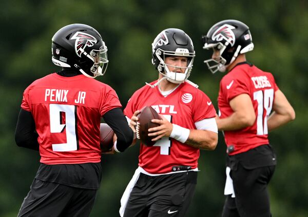 Atlanta Falcons quarterbacks (from left)  Michael Penix Jr. (9), Taylor Heinicke (4) and Kirk Cousins (18) practice during day 1 of Atlanta Falcons Training Camp on Thursday, July 25, 2024 in Flowery Branch. (Hyosub Shin / AJC)