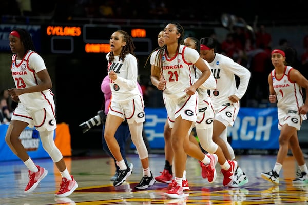 Georgia guard Reigan Richardson (21) runs off the court with teammates after a first round game against Dayton in the NCAA women's college basketball tournament, Friday, March 18, 2022, in Ames, Iowa. Georgia won 70-54. (AP Photo/Charlie Neibergall)