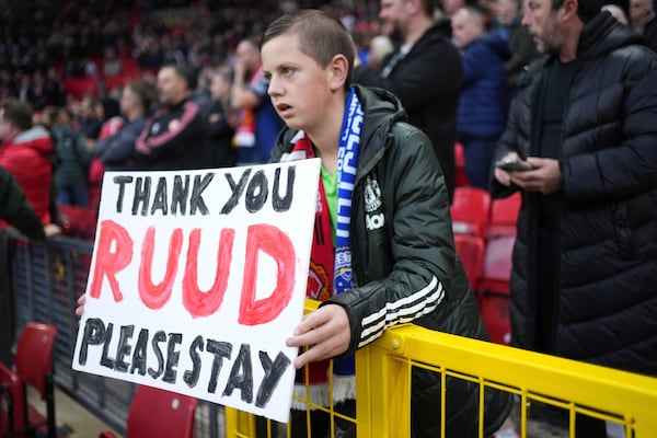 Manchester United supporter holds a banner reading 'Thank you Ruud, please stay' during the English Premier League soccer match between Manchester United and Leicester City, at the Old Trafford stadium in Manchester, England, Sunday, Nov.10, 2024. (AP Photo/Jon Super)