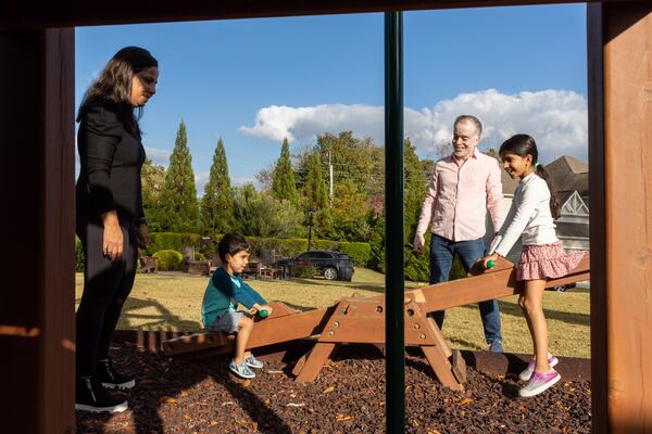 (L-R) Yogita, Kaveh, 3, Kaiya, 7, and Dhaval Desai play on a playground in Sandy Springs on Friday, October 27, 2023. (Arvin Temkar / arvin.temkar@ajc.com)