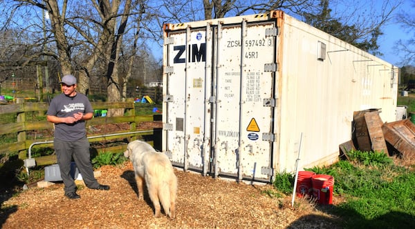 Shaun Terry, owner of Grateful Pastures in Mansfield, stands in front of a modified and insulated shipping container used as the brooder, the area where the baby chicks live until they're ready to go to the pasture enclosures. Chris Hunt for The Atlanta Journal-Constitution