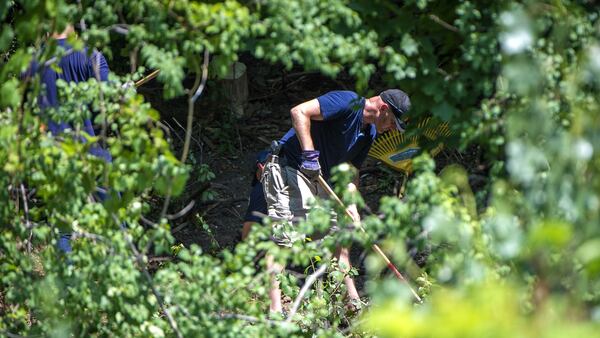 In this July 5, 2018, photo, members of the Toronto Police Service excavate a ravine behind a Mallory Crescent home connected to alleged serial killer Bruce McArthur. Toronto Inspector Hank Idsinga told reporters Friday, July 20, 2018, that the remains found during the nine-day search of the ravine earlier in the month have been positively identified as those of victim  Majeed “Hamid” Kayhan. Kayhan, 58, vanished in October 2012 from Toronto's Gay Village.