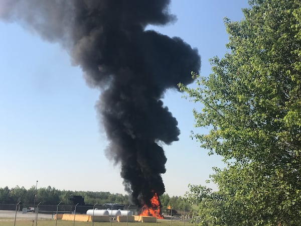 A column of smoke rises into the sky during a live burn training exercise at the Atlanta airport fire training center next to Hartsfield-Jackson International. The airport holds weekly live burn exercises through much of the year.