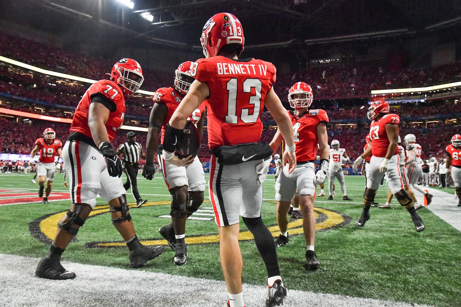 Georgia Bulldogs quarterback Stetson Bennett (13) celebrates with teammates after he scored on a keeper. (Hyosub Shin / Hyosub.Shin@ajc.com)