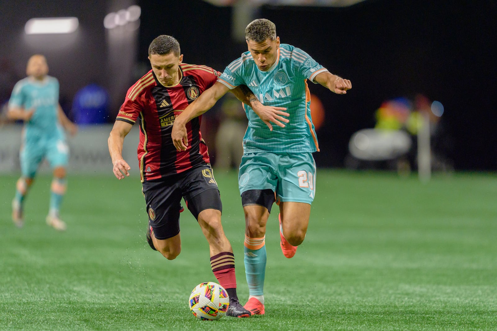 Inter Miami midfielder Diego Gómez (20) and Atlanta United midfielder Bartosz Slisz (6) fight for possession of the ball during the first half of an MLS soccer match Saturday, Nov. 2, 2024, in Atlanta. (AP Photo/Jason Allen)