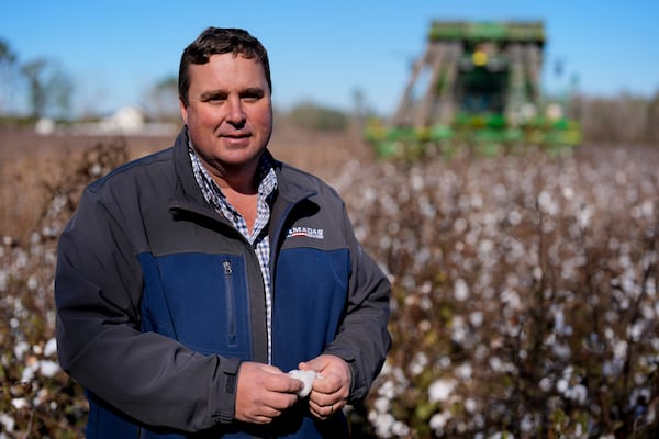 FILE - Farmer Chris Hopkins stands in one of his cotton fields before being harvested, Friday, Dec. 6, 2024, near Lyons, Ga. (AP Photo/Mike Stewart, File)