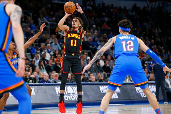 Atlanta Hawks guard Trae Young (11) shoots near Oklahoma City Thunder forward Lindy Waters III (12) during the first half of an NBA basketball game Wednesday, March 30, 2022, in Oklahoma City. (AP Photo/Nate Billings)