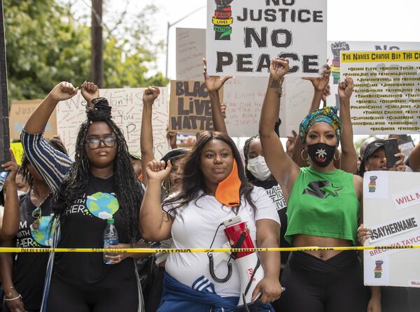 “Say Her Name” rally and march organizers Zoe Bambara (from left) and Mary-Pat Hector stand in solidarity with Porsha Williams, granddaughter of Hosea Williams, and hundreds of other supporters before they march to Atlanta City Hall during the 10th day of protests in Atlanta. ALYSSA POINTER / ALYSSA.POINTER@AJC.COM