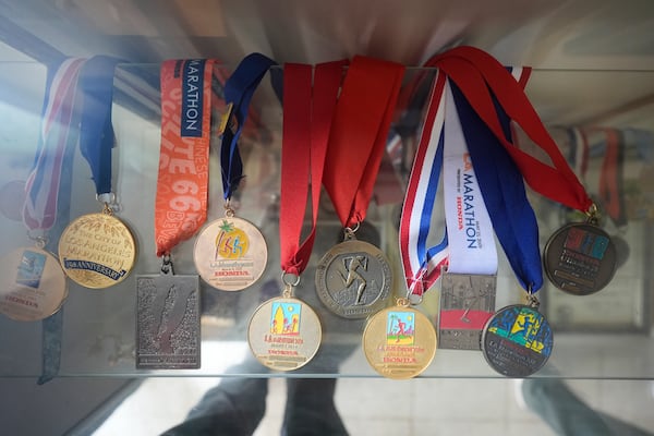 The Los Angeles Marathon medals from Rick Bingham, 87, are displayed at his home in Lake Elsinore, Calif., Tuesday, March 11, 2025. (AP Photo/Damian Dovarganes)