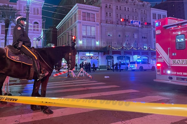 A mounted police officer arrives on Canal Street after a vehicle drove into a crowd earlier in New Orleans, Wednesday Jan. 1, 2025. (AP Photo/Kevin McGill)