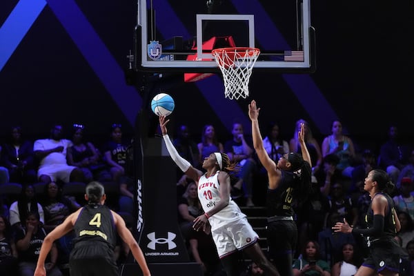 Vinyl wing Rhyne Howard (10) shoots around the defense of Lunar Owls wing Allisha Gray in their Unrivaled 3-on-3 basketball semifinal, Sunday, March 16, 2025, in Medley, Fla. (AP Photo/Rebecca Blackwell)