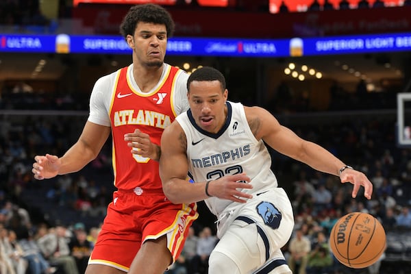 Memphis Grizzlies guard Desmond Bane handles the ball against Atlanta Hawks forward Dominick Barlow in the first half of an NBA basketball game, Monday, March 3, 2025, in Memphis, Tenn. (AP Photo/Brandon Dill)