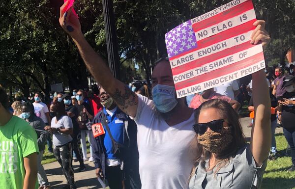 Cheston Bromwell, 41, and Rachel Thompson, 30, demonstrate at a rally in downtown Brunswick a day after arrests were announced in the Feb. 23 shooting death of Ahmaud Arbery. (Photo: Bert Roughton/For The AJC)