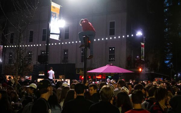 University of Georgia students and fans flood the streets to celebrate a Bulldog victory in the College Football Championship on Monday, January 9, 2023, in downtown Athens, Georgia. The University of Georgia defeated the Texas Christian University football team 65-7. CHRISTINA MATACOTTA FOR THE ATLANTA JOURNAL-CONSTITUTION.