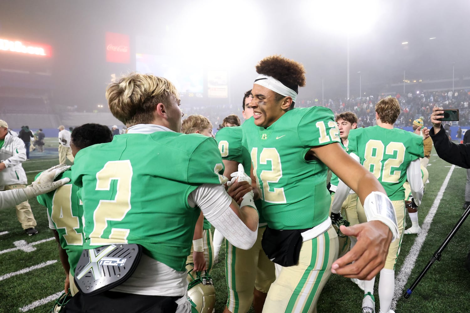 Buford defensive back Jake Pope (2) celebrates with quarterback Ashton Daniels (12) after their 21-20 win against Langston Hughes during the Class 6A state title football game at Georgia State Center Parc Stadium Friday, December 10, 2021, Atlanta. JASON GETZ FOR THE ATLANTA JOURNAL-CONSTITUTION