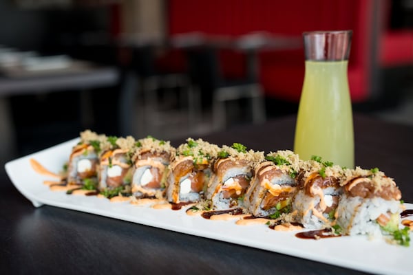  CO Kung Fu Crunch sushi roll with salmon, avocado, cream cheese, spicy tuna, unagi sauce, spicy aioli, and tempura flakes, with Cucumber Sake Infusion. Photo credit- Mia Yakel.