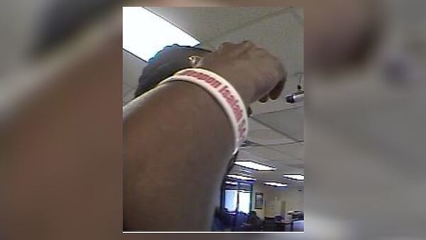 A man wore a bracelet with a Bible verse when he withdrew “a significant amount of fraudulently obtained funds” from a metro Atlanta bank, the FBI said Friday. The bracelet referenced Isaiah 54:17. (Credit: FBI)