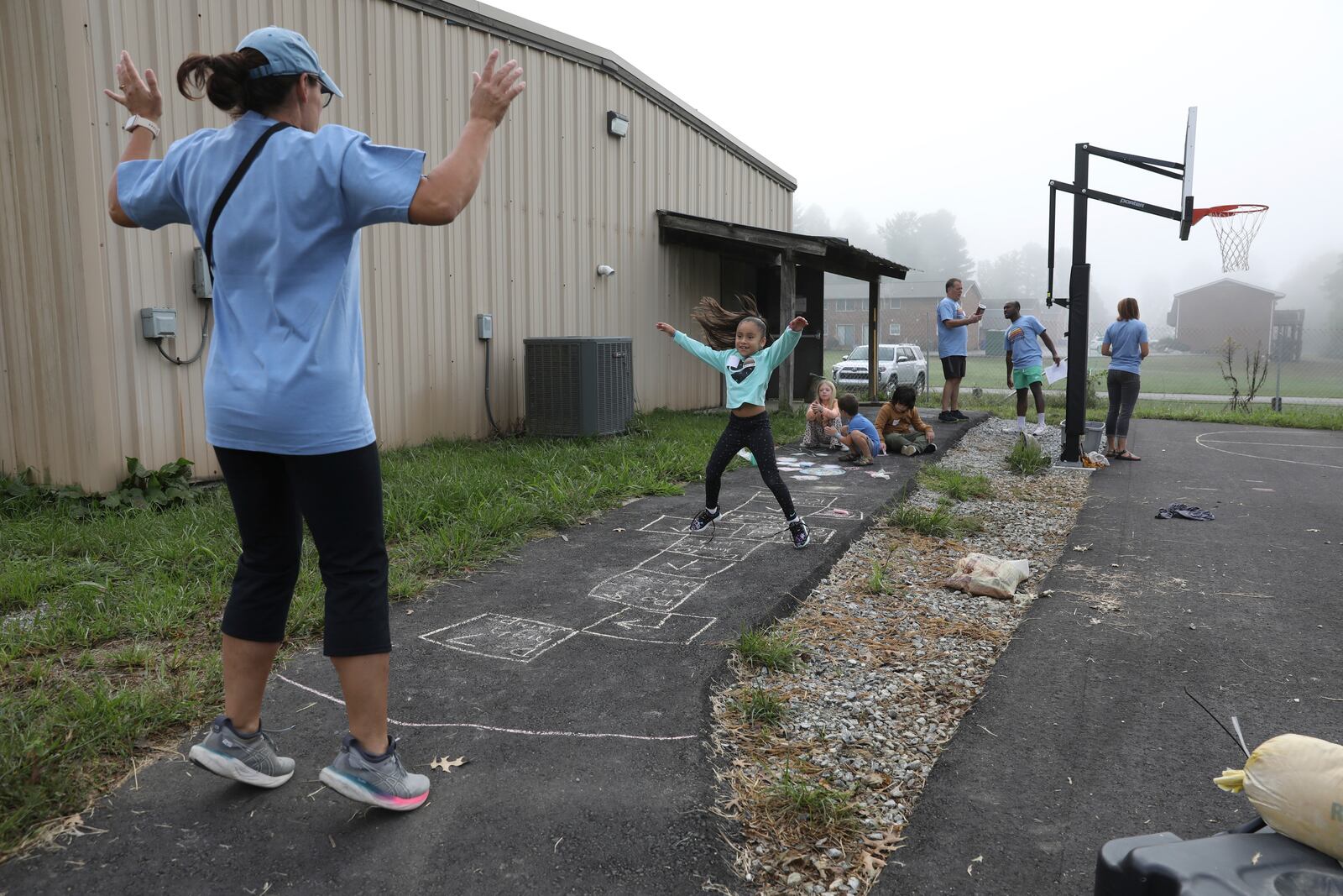 A girl plays hopscotch at the Project:Camp pop-up daycamp for families impacted by Hurricane Helene in Brevard, N.C., Monday, Oct. 7, 2024. (AP Photo/Gabriela Aoun Angueira)