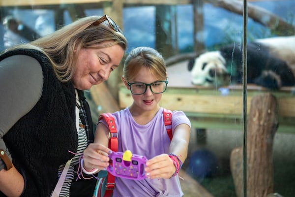 Alexis Patterson with her daughter 9-year-old Tyra Patterson and giant panda Yang Yang during Zoo Atlanta’s Farewell Visit with the giant pandas in October. The four pandas, Lun Lun, Yang Yang and their twins Ya Lun and Xi Lun, left Atlanta for China a week later.  (Jenni Girtman for The Atlanta Journal-Constitution)