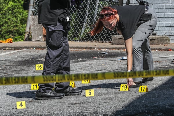 Investigators placed more than a dozen evidence markers in the parking lot that appeared to indicate spent shell casings.