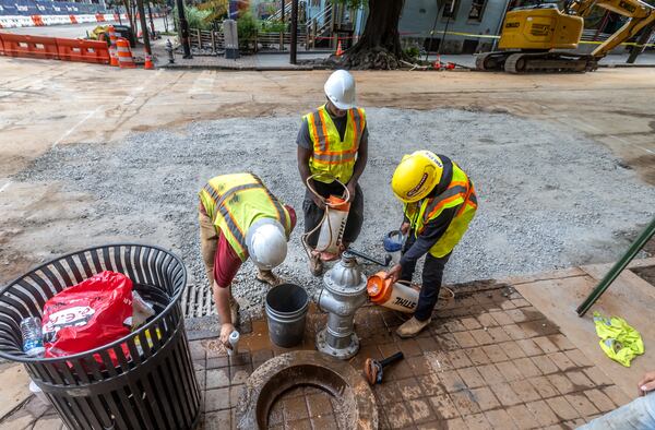 Workers repairing last month's main break at West Peachtree and 11th streets in Midtown.