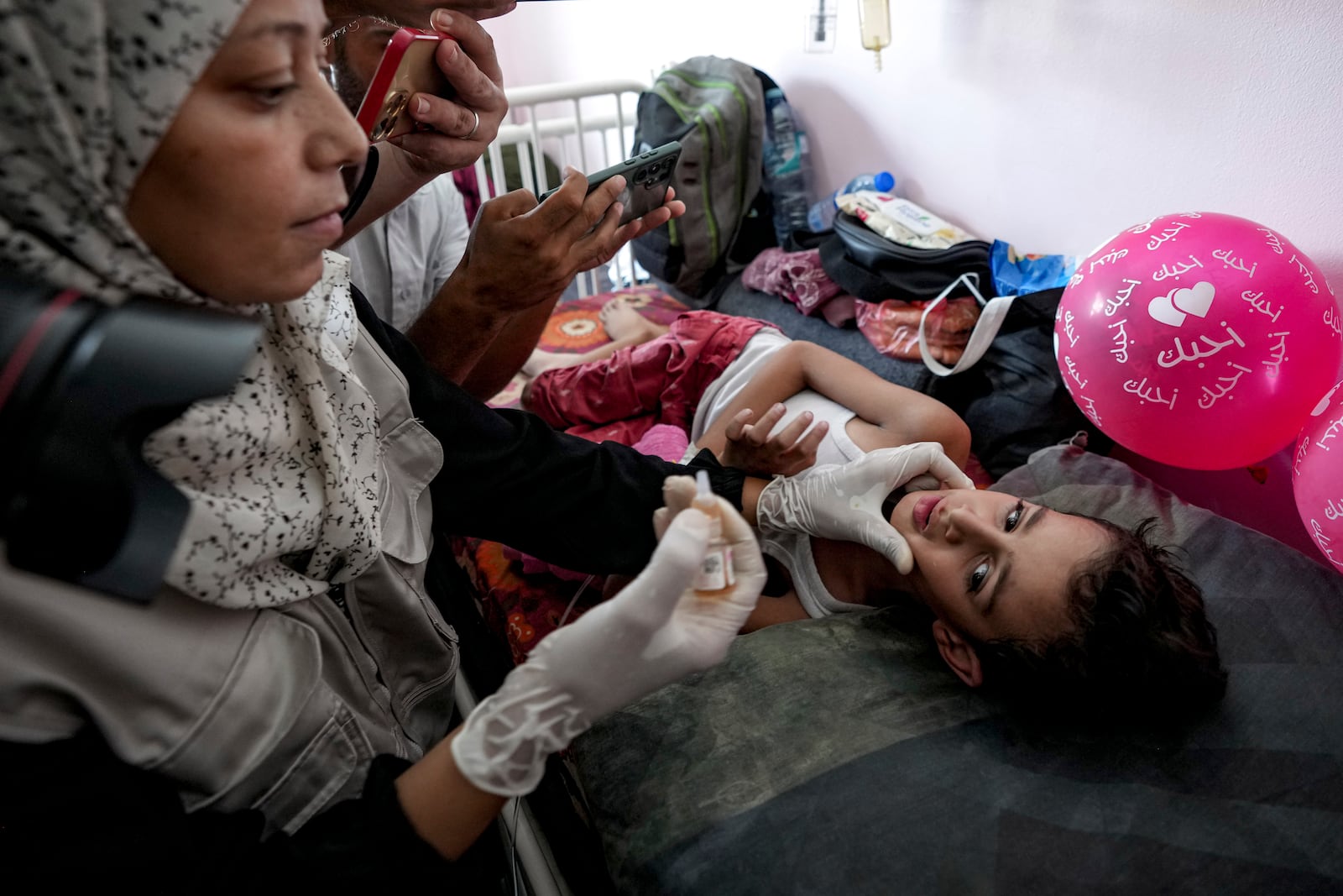 A health worker administers a polio vaccine to a child at a hospital in Khan Younis, Saturday, Aug. 31, 2024. Abdel Kareem Hana/AP