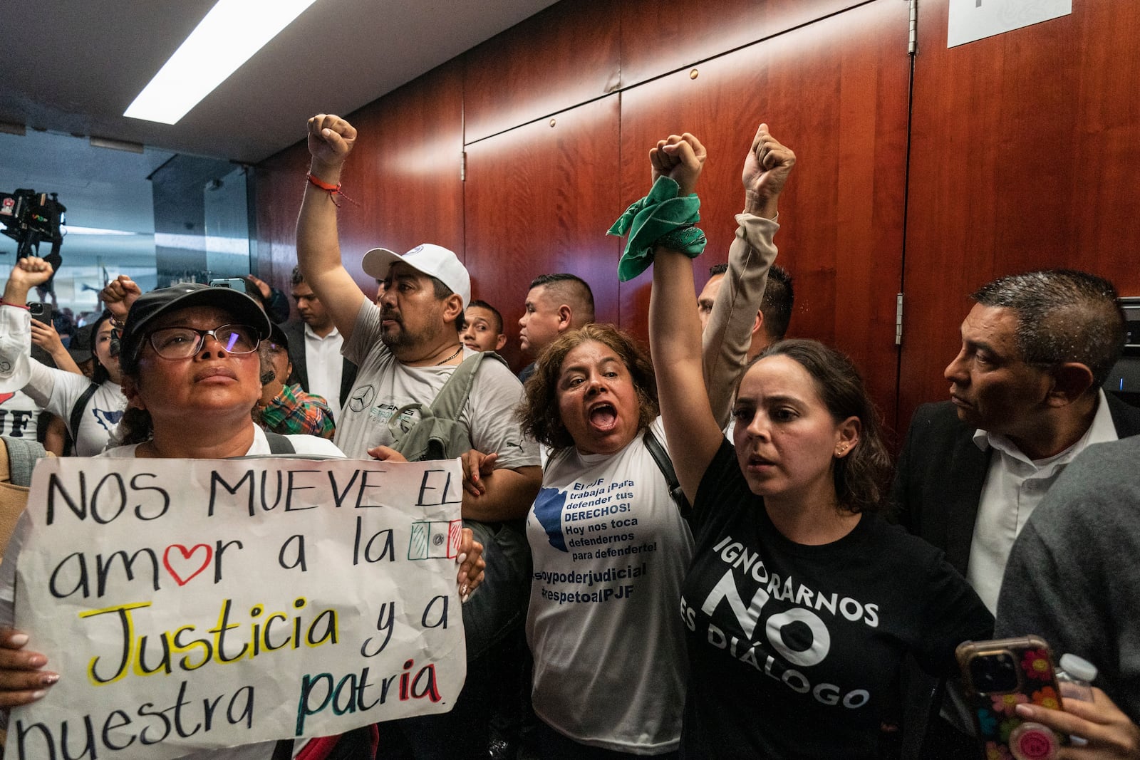 Protesters attempt to break into a Senate room in which lawmakers weigh the government's proposed judicial reform, which would make judges stand for election, in Mexico City, Tuesday, Sept. 10, 2024. (AP Photo/Felix Marquez)