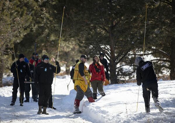 El Paso County law enforcement and volunteers use poles to search snowy areas for 11-year-old missing Colorado Springs boy Gannon Stauch on private property in southern Douglas County, Colorado. The boy’s stepmother has been arrested, but the search for him continues.