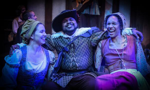 Porthos (O’Neil Delapenha, center) enjoys a drink and good company with barmaids (Samantha Lancaster, left, and Imani Joseph, right).