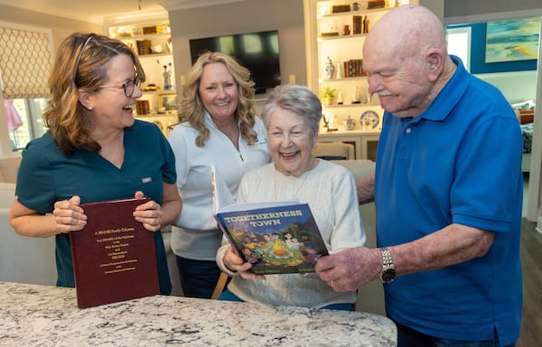 Beth Wilson (from left), Tina Boggs and Ruth and Bill Renner chat about Wilson's new book at the Renners' Gainesville home. Wilson, a caregiver with Seniors Helping Seniors of Hall, Forsyth, and Barrow Counties, has formed a deep bond with her clients, Bill and Ruth Renner, both in their mid-90s. PHIL SKINNER FOR THE ATLANTA JOURNAL-CONSTITUTION