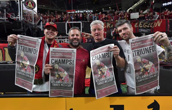 December 8, 2018 Atlanta - Atlanta United fans hold Atlanta Journal-Constitution stadium edition after Atlanta United beat the Portland Timbers during MLS championship on Saturday, December 8, 2018. HYOSUB SHIN / HSHIN@AJC.COM