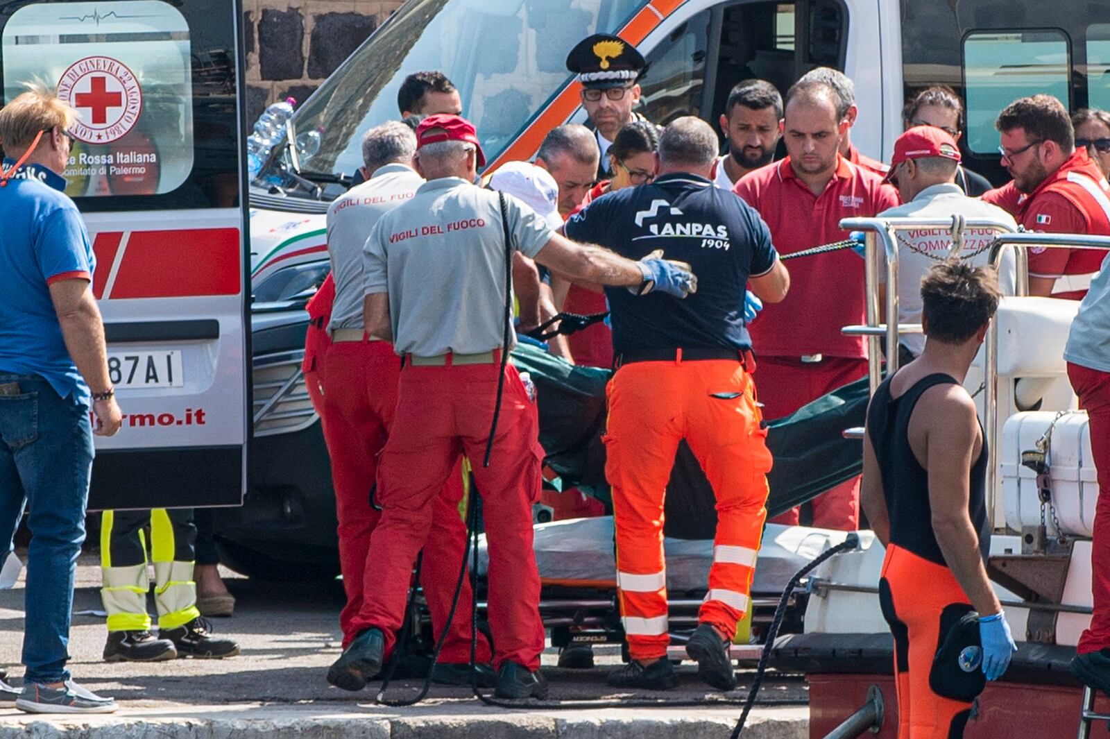 Rescuers recoup the body of one of the victims of the UK flag vessel Bayesan that sunk early Monday, Aug. 19, 2024, while at anchor off the Sicilian village of Porticello near Palermo, in southern Italy. (AP Photo/Lucio Ganci)