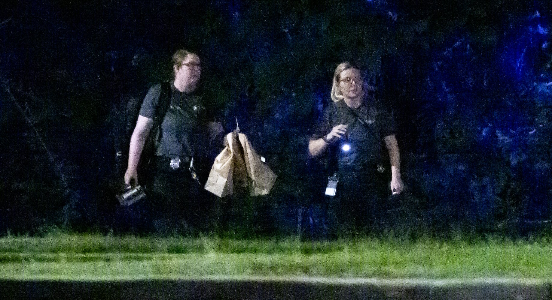 Investigators examine the scene of a shooting, where a man and three children shot to death inside a car at Lucky Shoals Park outside of Tucker on Wednesday, May 8, 2024. The man was in the driver’s seat. He, a boy and two girls all appeared to have been shot. Their names and ages were not released, but authorities said the children appeared to have been in elementary and middle school.  (John Spink/AJC)