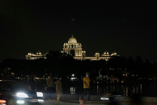 A crescent moon is seen above the Telangana State Secretariat building the day before the first daily fast of the Islamic holy month of Ramadan, in Hyderabad, India, Saturday, March 1, 2025. (AP Photo/Mahesh Kumar A.)