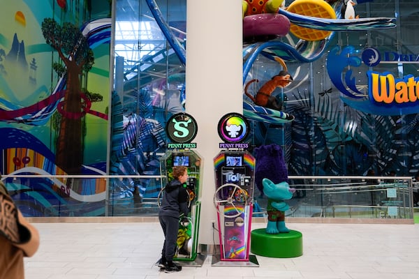 A boy plays with a penny press machine at the American Dream mall, Sunday, March 2, 2025, in East Rutherford, N.J. (AP Photo/Julia Demaree Nikhinson)