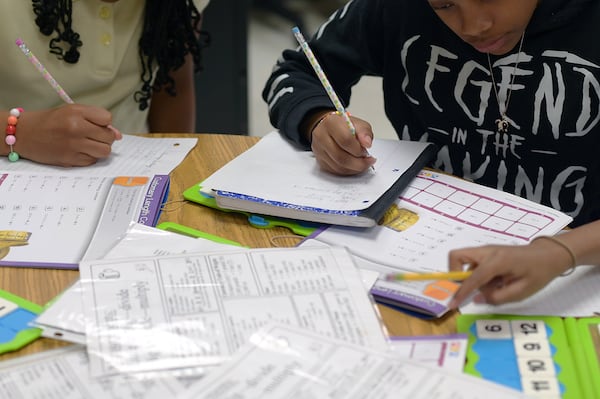 A group of fifth grade students at Thurgood Marshall Elementary in Morrow, Georgia, work on math problems during class on April 19, 2022. Students across the state will be taking the Georgia Milestones in April and May. (Natrice Miller / natrice.miller@ajc.com)