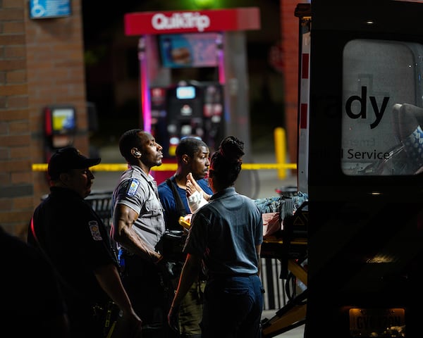 Atlanta fire and Grady EMS personnel move a gunshot victim to the ambulance on Saturday, August 13, 2022. Police said the victim is connected to the shooting at the lounge. (Photo: Ben Hendren for The Atlanta Journal-Constitution)