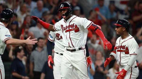 Atlanta Braves left fielder Ronald Acuna celebrates hitting a grand slam against the Los Angeles Dodgers in Game 3 of a National League Division Series baseball Sunday, Oct. 7, 2018, at SunTrust Park in Atlanta.