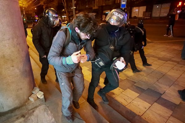 Police detain a protester outside the parliament building in Tbilisi, Georgia, on Friday, Nov. 29, 2024. (AP Photo/Zurab Tsertsvadze)