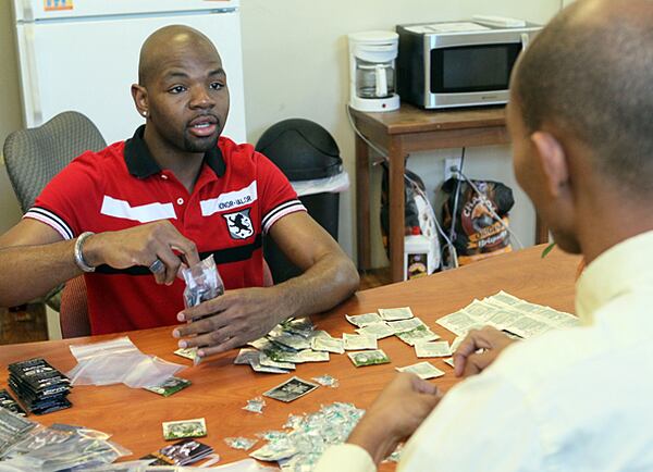 TIm Ward (left), an HIV positive volunteer at Evolution Project, chats with Antoine Bates as they package free condoms at the drop-in community center for young black gay men between 18 and 28 years of age. Ward is among the growing number of black gay men who account for 61 percent of new HIV infections in the country.