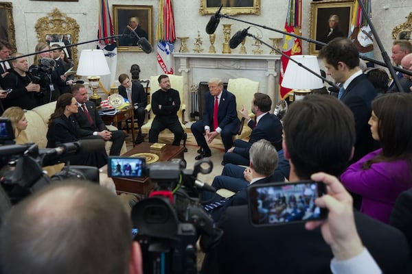 Vice President JD Vance, center right, speaks with Ukrainian President Volodymyr Zelenskyy, center left, as President Donald Trump, center, listens in the Oval Office at the White House, Friday, Feb. 28, 2025, in Washington. (AP Photo/ Mystyslav Chernov)