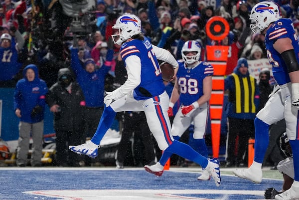 Buffalo Bills quarterback Josh Allen (17) carries the ball into the end zone to score a touchdown against the Baltimore Ravens during the second quarter of an NFL divisional playoff football game, Sunday, Jan. 19, 2025, in Orchard Park, N.Y. (AP Photo/Gene J. Puskar)