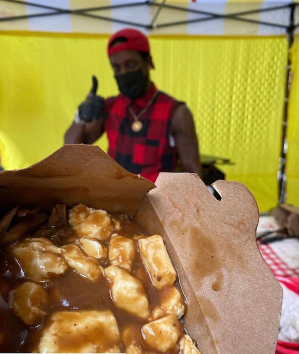 Tony Jackson serves up poutine at a Pat's Poutine pop-up. / Courtesy of Pat's Poutine