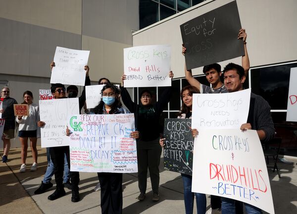 Cross Keys students and supporters show signs that support the efforts to renovate Cross Keys High School outside of the DeKalb County School System Administrative and Instructional Complex during a DeKalb County School District meeting Monday, April 18, 2022, in Stone Mountain. (Jason Getz / AJC file photo)