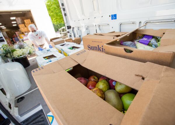 Ned Cone volunteers with Second Helpings Atlanta picking up food at Sprouts and Trader Joe's on June 2. The new partnership will use Second Helpings' fleet of vehicles and volunteers. (Jenni Girtman for The Atlanta Journal-Constitution)