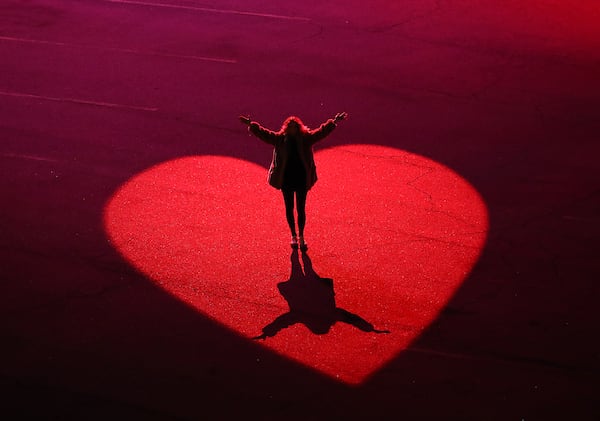 Artist/curator Courtney Hammond stands on part of the heartbeat-based art installation she helped create where Centennial Yards has turned the Gulch into a Heartbeat ATL art installation on Monday, Jan. 31, 2022, in Atlanta. People have described the area to be a ”hole in the heart" of Atlanta for years, a boring expanse of parking lots. Centennial Yards, the folks building a work-play-shop area there, teamed with some local artists to create a heartbeat-based light installation that can be triggered by a website you can got to by scanning QR codes set up around the area. Curtis Compton / Curtis.Compton@ajc.com