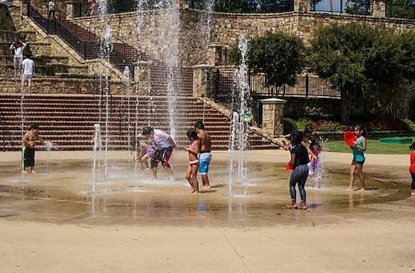 Kids play in the splash pad at Lillian Webb Park in Norcross.